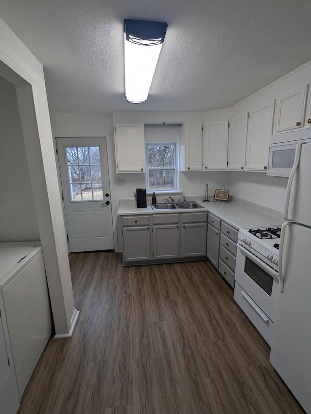 505 W Worley St, Columbia, MO 65203 - kitchen featuring white appliances, white cabinets, a textured ceiling, dark wood-style flooring, and plenty of natural light