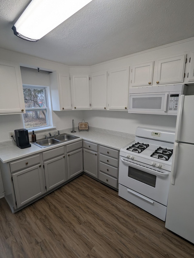 505 W Worley St, Columbia, MO 65203 - kitchen featuring white appliances, gray cabinetry, dark wood finished floors, light countertops, and a textured ceiling