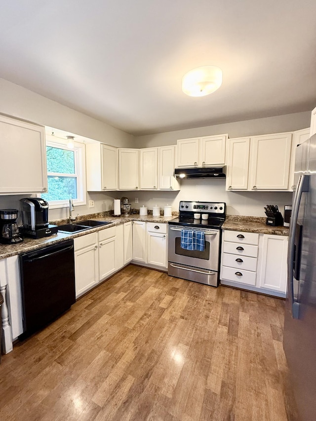 3900 E Christian School Rd, Hartsburg, MO 65039 - kitchen with appliances with stainless steel finishes, under cabinet range hood, light wood-type flooring, and white cabinets