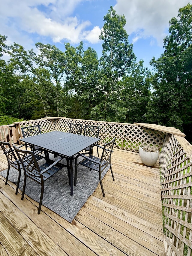 3900 E Christian School Rd, Hartsburg, MO 65039 - wooden deck featuring outdoor dining area and view of scattered trees