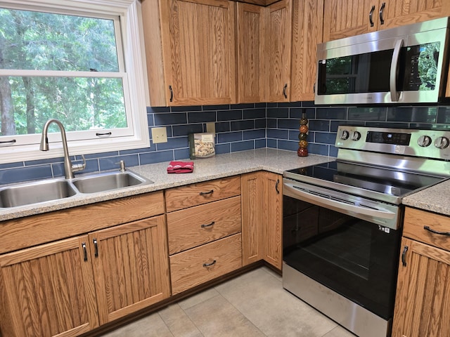 3109 Appalachian Dr, Columbia, MO 65203 - kitchen featuring stainless steel appliances, backsplash, light countertops, and light tile patterned floors
