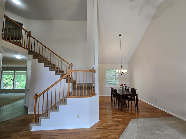 3109 Appalachian Dr, Columbia, MO 65203 - staircase featuring wood finished floors, a chandelier, and high vaulted ceiling