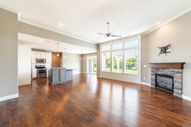 1915 Muirfield Dr, Columbia, MO 65203 - unfurnished living room featuring crown molding, a ceiling fan, a fireplace, dark wood finished floors, and recessed lighting