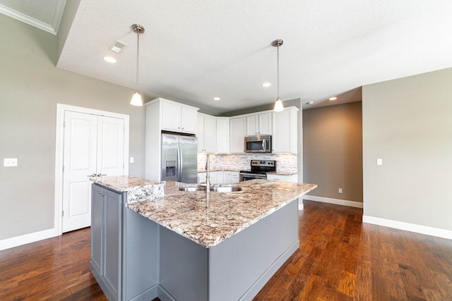 1915 Muirfield Dr, Columbia, MO 65203 - kitchen with appliances with stainless steel finishes, backsplash, a large island, white cabinets, and dark wood-style floors