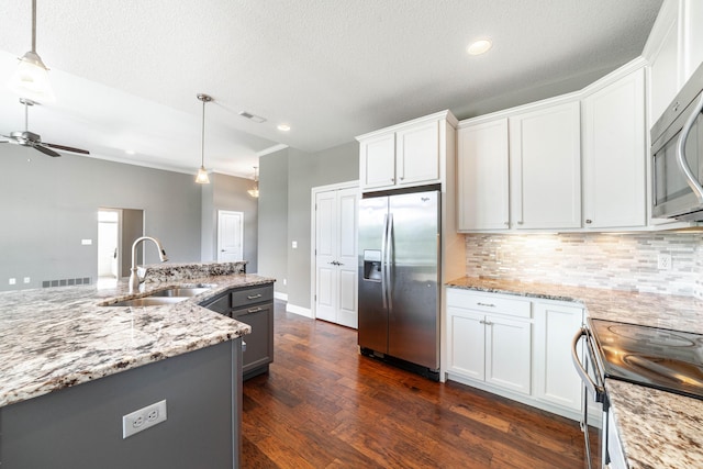 1915 Muirfield Dr, Columbia, MO 65203 - kitchen featuring appliances with stainless steel finishes, a ceiling fan, tasteful backsplash, white cabinets, and recessed lighting
