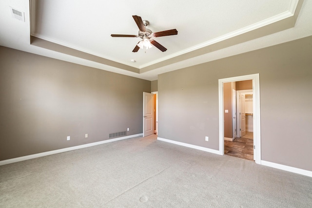 1915 Muirfield Dr, Columbia, MO 65203 - unfurnished bedroom featuring a tray ceiling, crown molding, carpet, and a ceiling fan