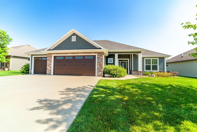 1915 Muirfield Dr, Columbia, MO 65203 - craftsman-style house with a garage, a front yard, stone siding, and concrete driveway