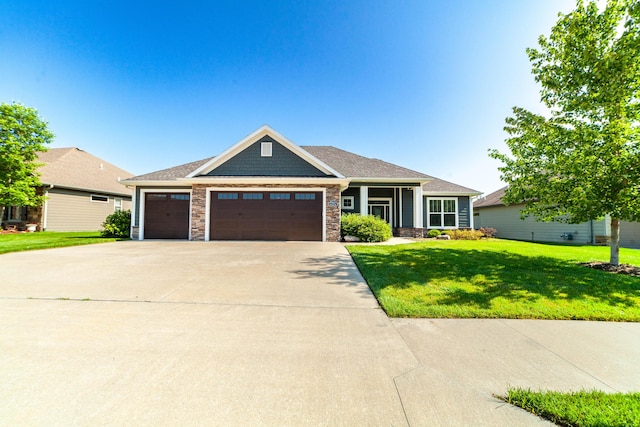 1915 Muirfield Dr, Columbia, MO 65203 - view of front of home with a front lawn, a garage, stone siding, and driveway