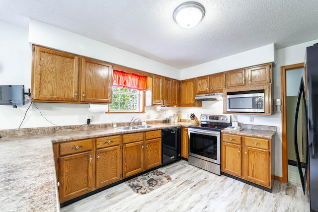 6002 E Molly Ln, Columbia, MO 65202 - kitchen featuring black appliances, a textured ceiling, and brown cabinets