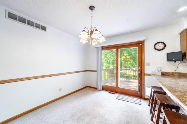 6002 E Molly Ln, Columbia, MO 65202 - unfurnished dining area with carpet flooring, a chandelier, and a textured ceiling