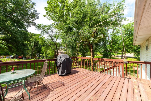 6002 E Molly Ln, Columbia, MO 65202 - wooden terrace with grilling area, outdoor dining area, and view of scattered trees