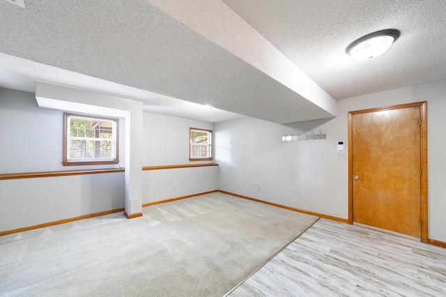 6002 E Molly Ln, Columbia, MO 65202 - basement with a textured ceiling, plenty of natural light, and wood finished floors