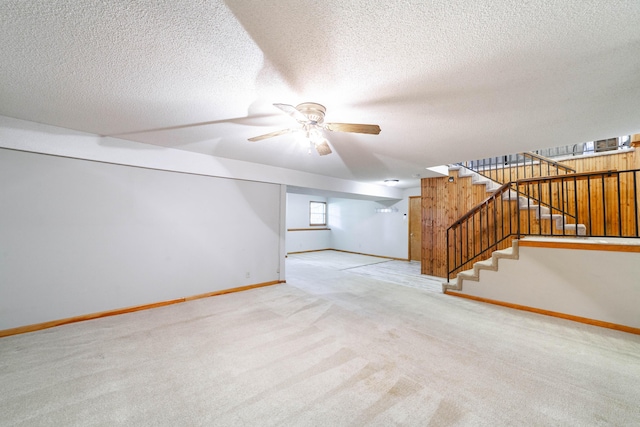 6002 E Molly Ln, Columbia, MO 65202 - unfurnished living room featuring stairway, carpet, ceiling fan, and a textured ceiling