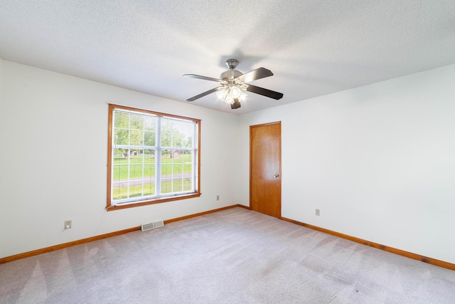 6002 E Molly Ln, Columbia, MO 65202 - spare room with light carpet, ceiling fan, and a textured ceiling