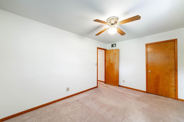 6002 E Molly Ln, Columbia, MO 65202 - unfurnished bedroom featuring carpet flooring and a ceiling fan