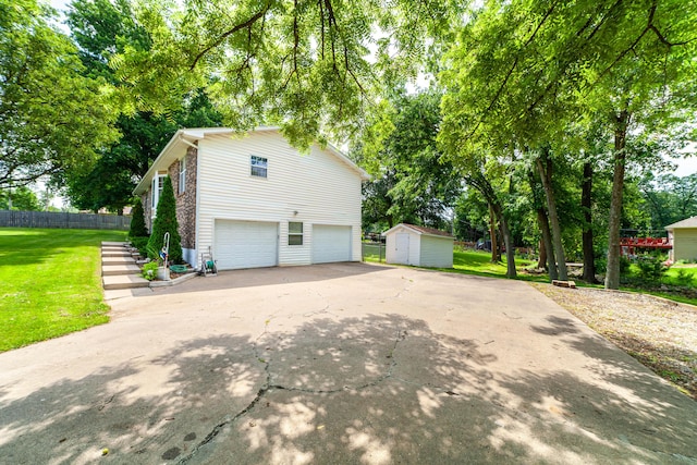 6002 E Molly Ln, Columbia, MO 65202 - view of home's exterior featuring a shed, a garage, and driveway