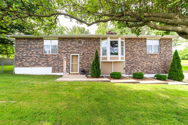 6002 E Molly Ln, Columbia, MO 65202 - raised ranch featuring brick siding, a chimney, and a patio area