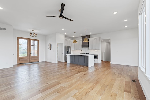 605 Angels Rest Way, Columbia, MO 65203 - unfurnished living room with a chandelier, light wood-style flooring, recessed lighting, a ceiling fan, and french doors