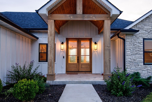 605 Angels Rest Way, Columbia, MO 65203 - view of exterior entry featuring stone siding, french doors, roof with shingles, and board and batten siding