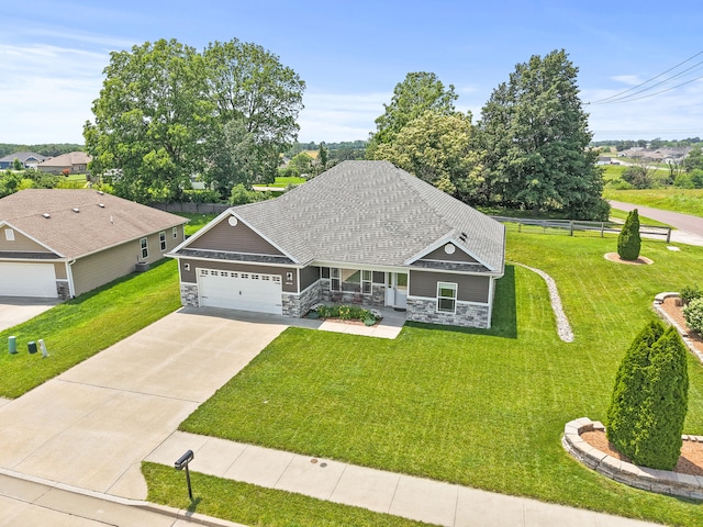 15409 Allegiance Ave, Ashland, MO 65010 - view of front of house with stone siding, covered porch, a garage, driveway, and roof with shingles