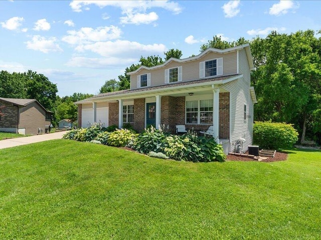 205 Johnson Ct, Ashland, MO 65010 - traditional-style home with a front yard, a garage, brick siding, and concrete driveway