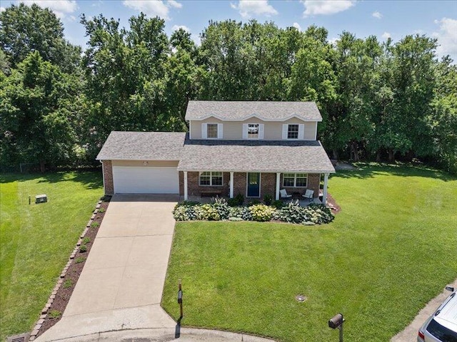 205 Johnson Ct, Ashland, MO 65010 - traditional-style home featuring covered porch, brick siding, a front yard, and concrete driveway