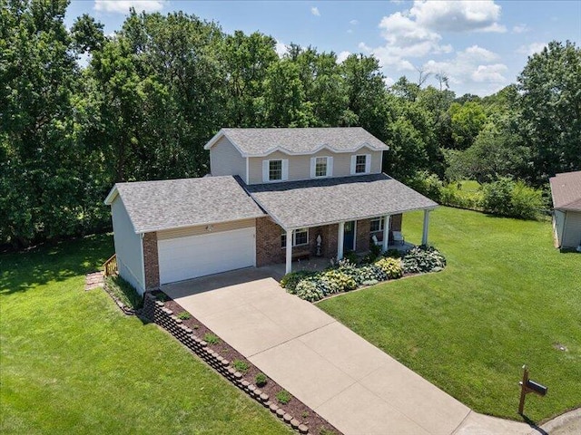 205 Johnson Ct, Ashland, MO 65010 - view of front of property featuring a porch, concrete driveway, a garage, brick siding, and a front yard