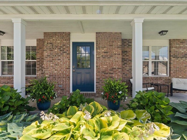 205 Johnson Ct, Ashland, MO 65010 - entrance to property featuring a porch and brick siding
