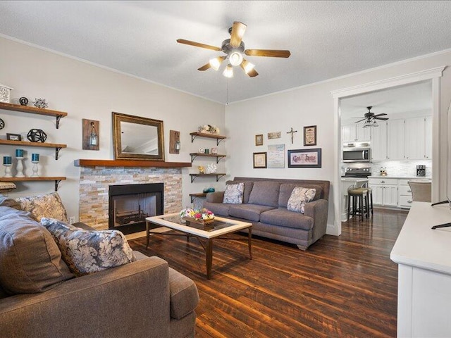 205 Johnson Ct, Ashland, MO 65010 - living room featuring ceiling fan, dark wood-style flooring, crown molding, and a stone fireplace