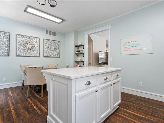 205 Johnson Ct, Ashland, MO 65010 - kitchen with dark wood-type flooring, white cabinets, light countertops, a center island, and ornamental molding