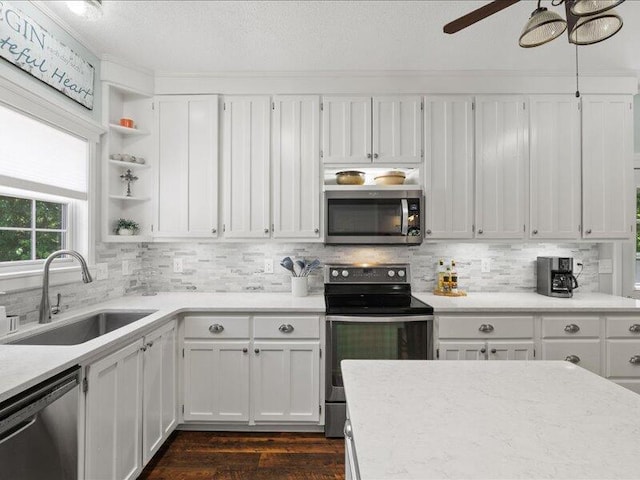 205 Johnson Ct, Ashland, MO 65010 - kitchen featuring appliances with stainless steel finishes, backsplash, light countertops, white cabinetry, and a textured ceiling