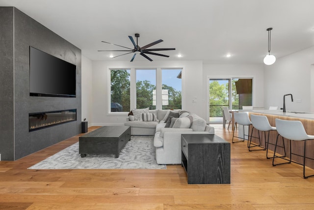 5413 Briar Rose Ct, Columbia, MO 65203 - living room featuring ceiling fan, light wood-style floors, recessed lighting, and a large fireplace