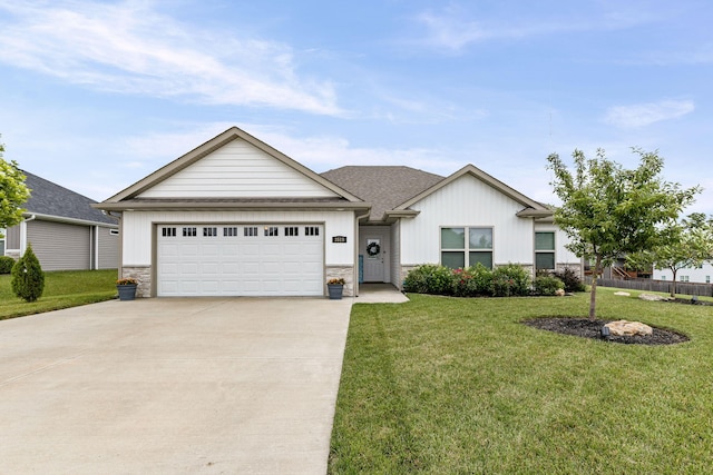 3515 Goldenwood Dr, Columbia, MO 65202 - ranch-style house featuring concrete driveway, a front yard, an attached garage, stone siding, and board and batten siding