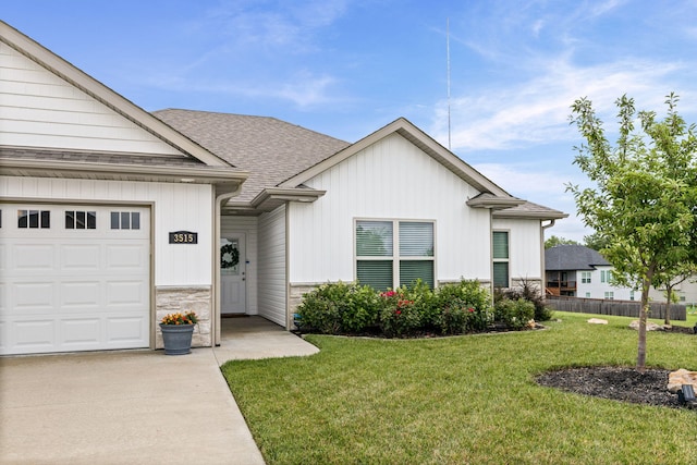 3515 Goldenwood Dr, Columbia, MO 65202 - view of front of property featuring stone siding, roof with shingles, driveway, and an attached garage