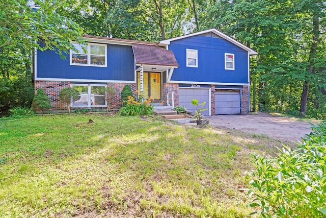 2808 Pine Dr, Columbia, MO 65202 - view of front of home featuring an attached garage, brick siding, asphalt driveway, and a front yard