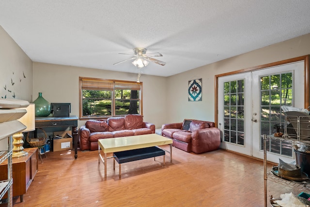 2808 Pine Dr, Columbia, MO 65202 - living area with light wood-style floors, french doors, a textured ceiling, and ceiling fan