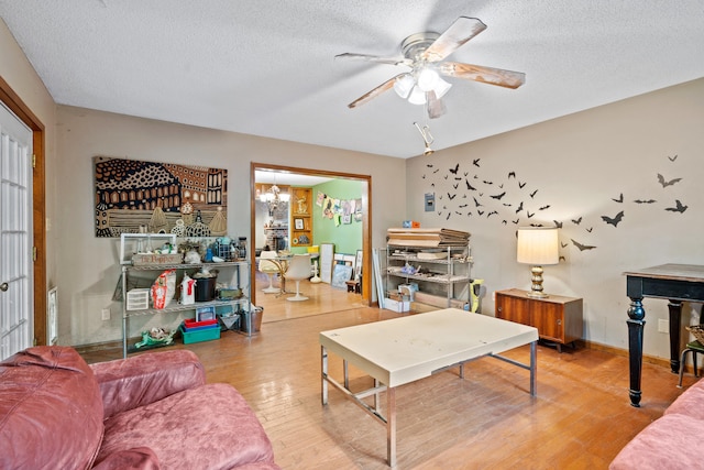 2808 Pine Dr, Columbia, MO 65202 - living area featuring light wood-style floors, a textured ceiling, ceiling fan, and a chandelier