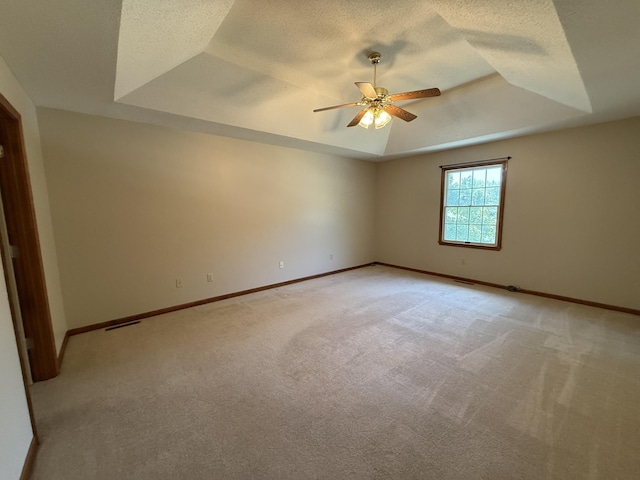 4413 Shoram Ct, Columbia, MO 65203 - unfurnished room featuring a tray ceiling, a ceiling fan, light carpet, and a textured ceiling