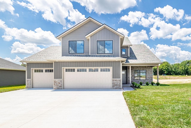 3321 Gray Birch Dr, Columbia, MO 65202 - view of front of home featuring board and batten siding, stone siding, a front yard, and concrete driveway