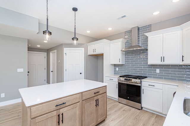 3321 Gray Birch Dr, Columbia, MO 65202 - kitchen with stainless steel gas range oven, wall chimney range hood, light wood-style floors, backsplash, and light countertops