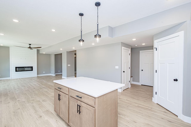 3321 Gray Birch Dr, Columbia, MO 65202 - kitchen featuring light brown cabinetry, ceiling fan, light wood-style flooring, pendant lighting, and a kitchen island