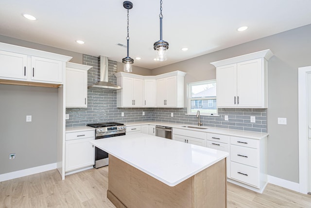 3321 Gray Birch Dr, Columbia, MO 65202 - kitchen featuring stainless steel appliances, wall chimney exhaust hood, light wood-style floors, tasteful backsplash, and recessed lighting