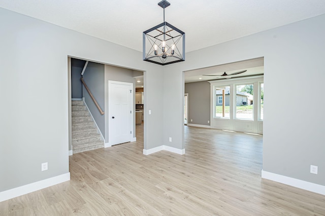 3321 Gray Birch Dr, Columbia, MO 65202 - empty room with stairway, light wood-style flooring, a chandelier, and ceiling fan