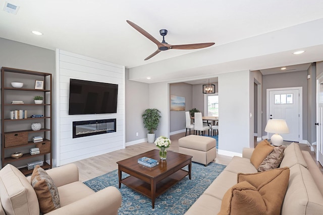 3321 Gray Birch Dr, Columbia, MO 65202 - living room featuring a ceiling fan, a fireplace, wood finished floors, and recessed lighting