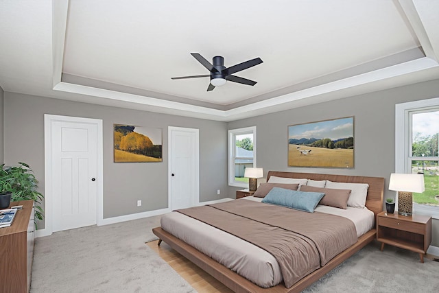 3321 Gray Birch Dr, Columbia, MO 65202 - carpeted bedroom featuring a raised ceiling, multiple windows, and ceiling fan