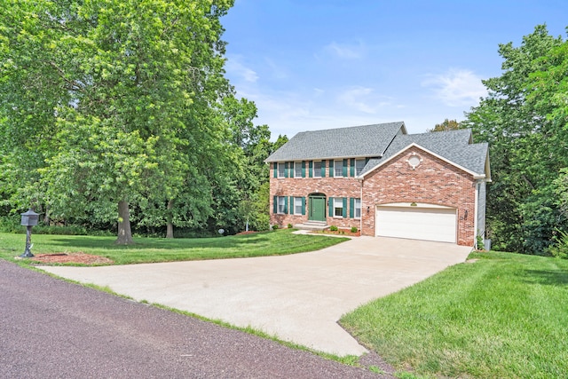 3348 S Old Ridge Rd, Columbia, MO 65203 - colonial-style house with brick siding, concrete driveway, roof with shingles, a front yard, and an attached garage