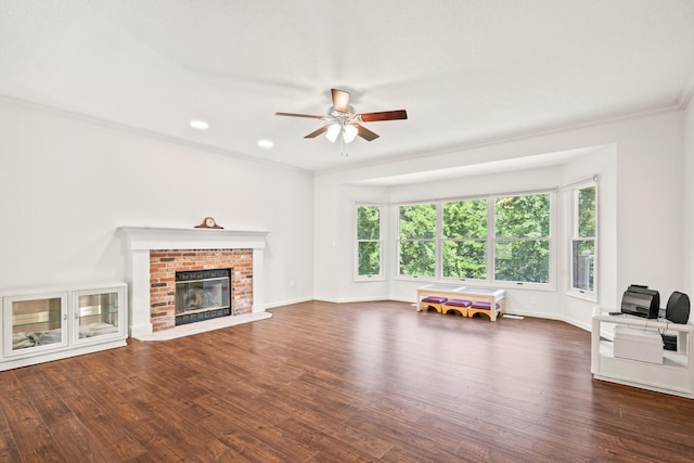 3348 S Old Ridge Rd, Columbia, MO 65203 - unfurnished living room with ornamental molding, wood finished floors, a ceiling fan, a brick fireplace, and recessed lighting