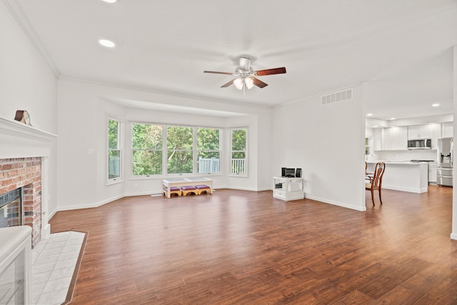 3348 S Old Ridge Rd, Columbia, MO 65203 - living area featuring a ceiling fan, wood finished floors, a fireplace, ornamental molding, and recessed lighting