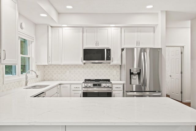 3348 S Old Ridge Rd, Columbia, MO 65203 - kitchen featuring appliances with stainless steel finishes, light stone counters, backsplash, white cabinetry, and recessed lighting