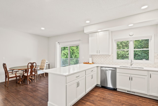 3348 S Old Ridge Rd, Columbia, MO 65203 - kitchen featuring dishwasher, a peninsula, dark wood-type flooring, white cabinetry, and light countertops
